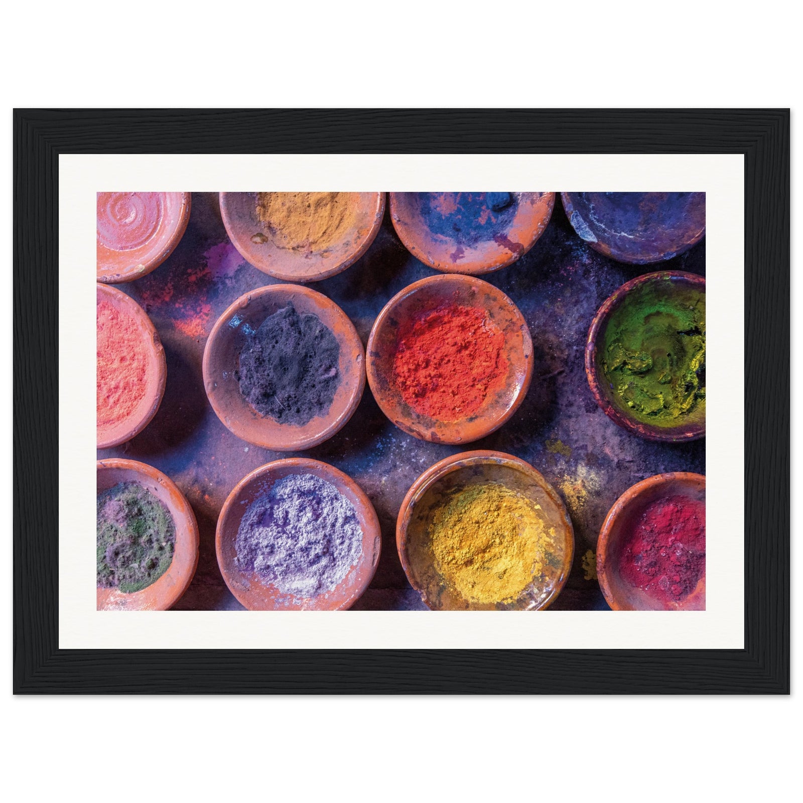Framed image showing festive colored powders in round containers.