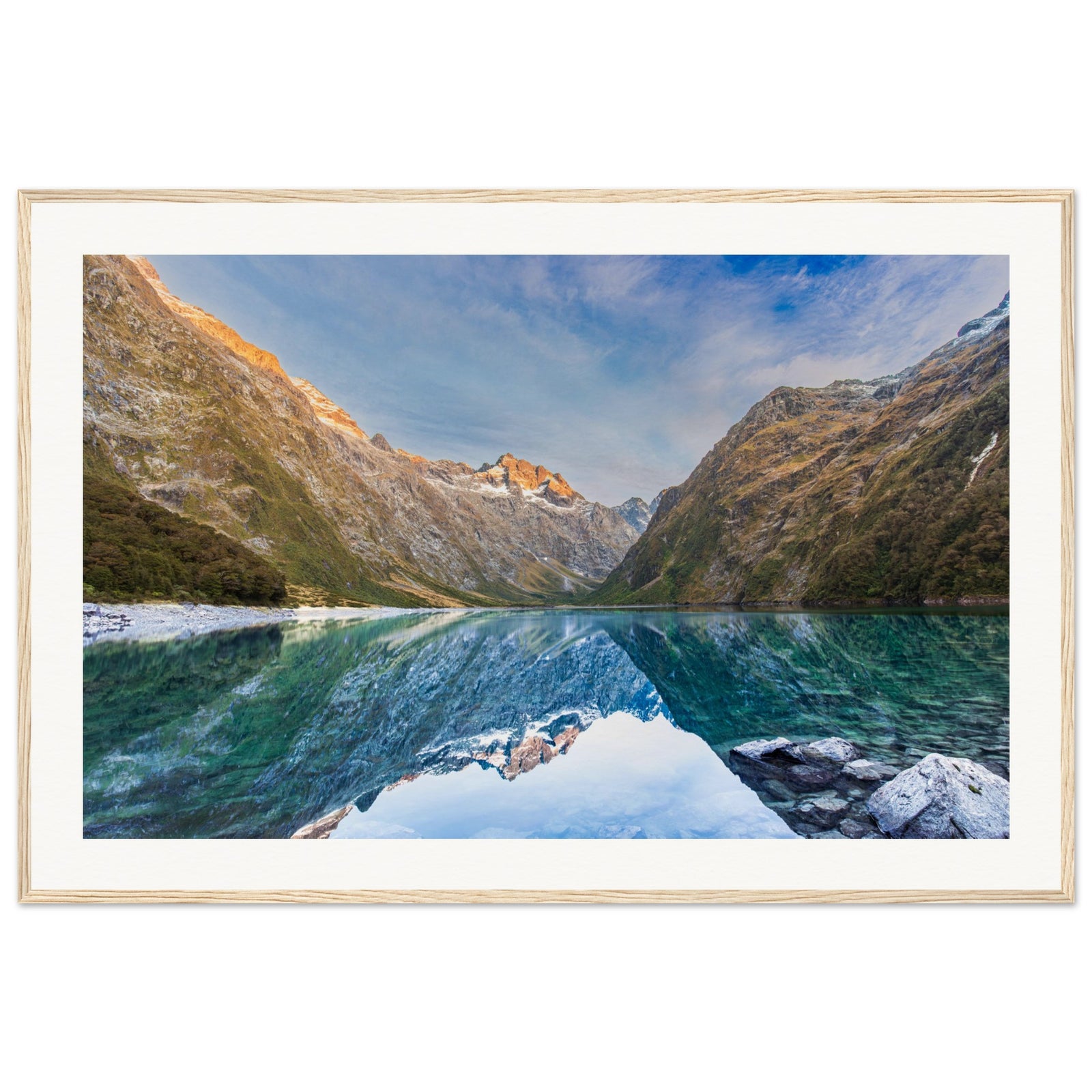 Portrait view of pristine waters and rugged mountains with a blue point.