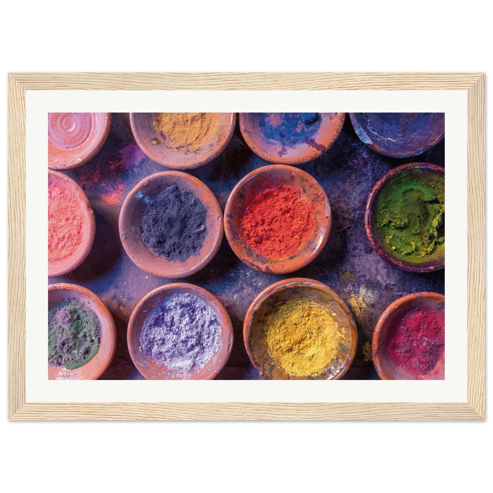 Pigment bowls arranged in a neat pattern in a framed portrait.