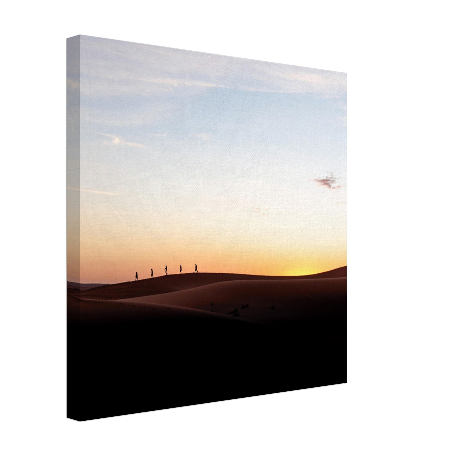 Peaceful desert scene with people silhouetted at dusk.