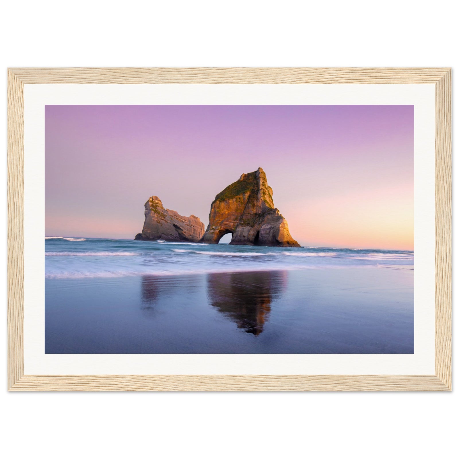Evening seascape with arch-shaped rock formation and waves.