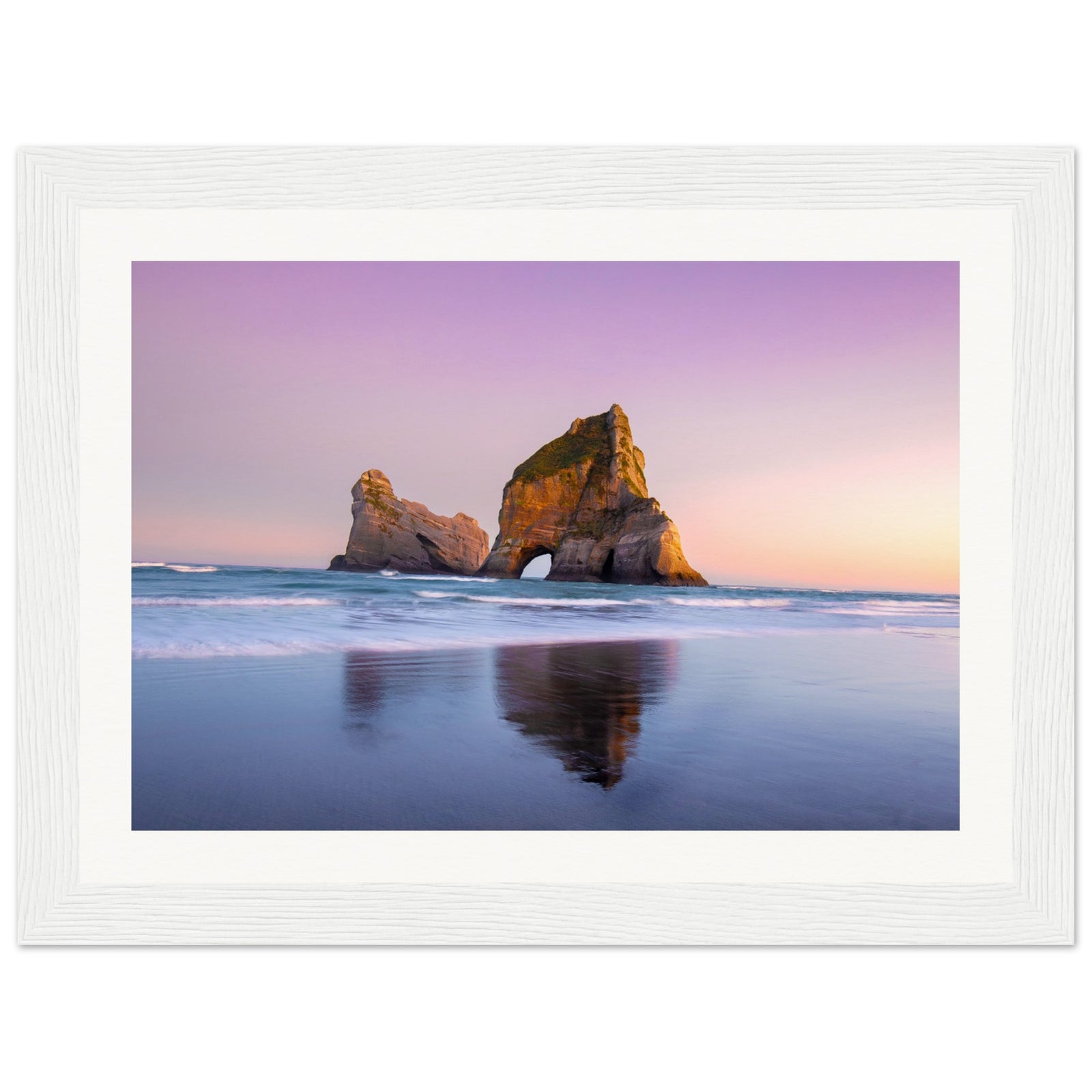 Portrait of coastal rocks and gentle sea under twilight.