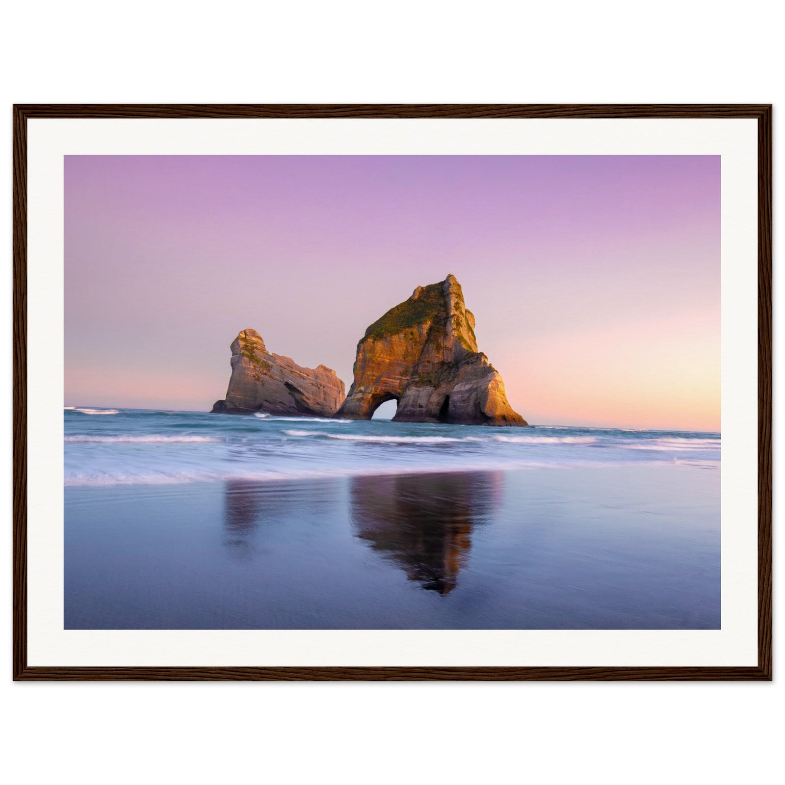 Dusk scene with sea arch and still water in vertical format.