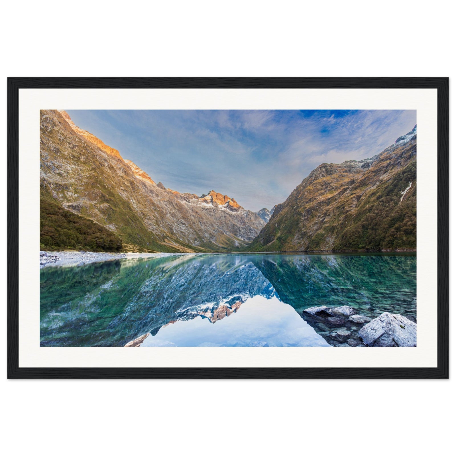 Framed portrait of a mountain lake scene with a blue dot on the slope.