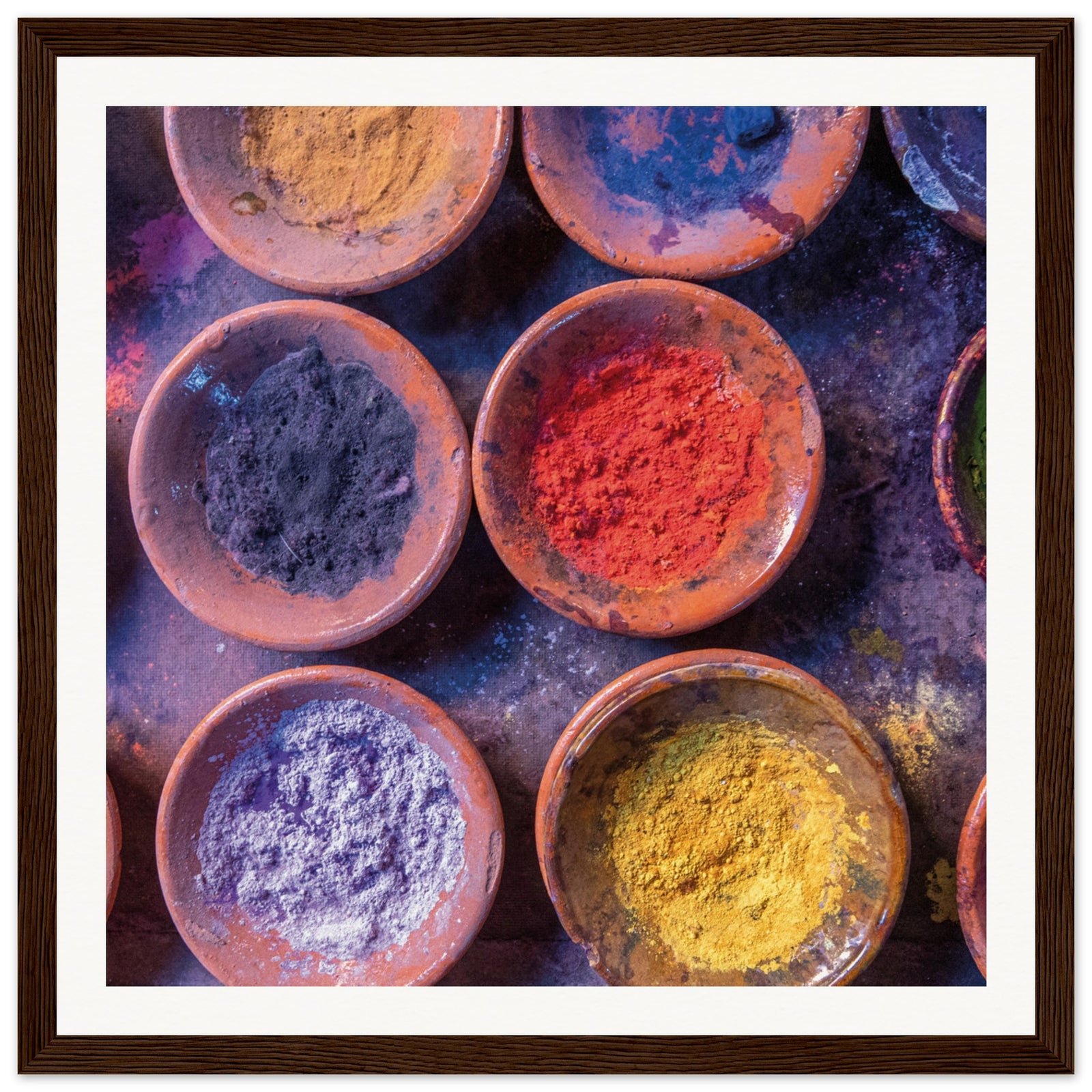 Decorative display of colorful powders arranged in a framed print.
