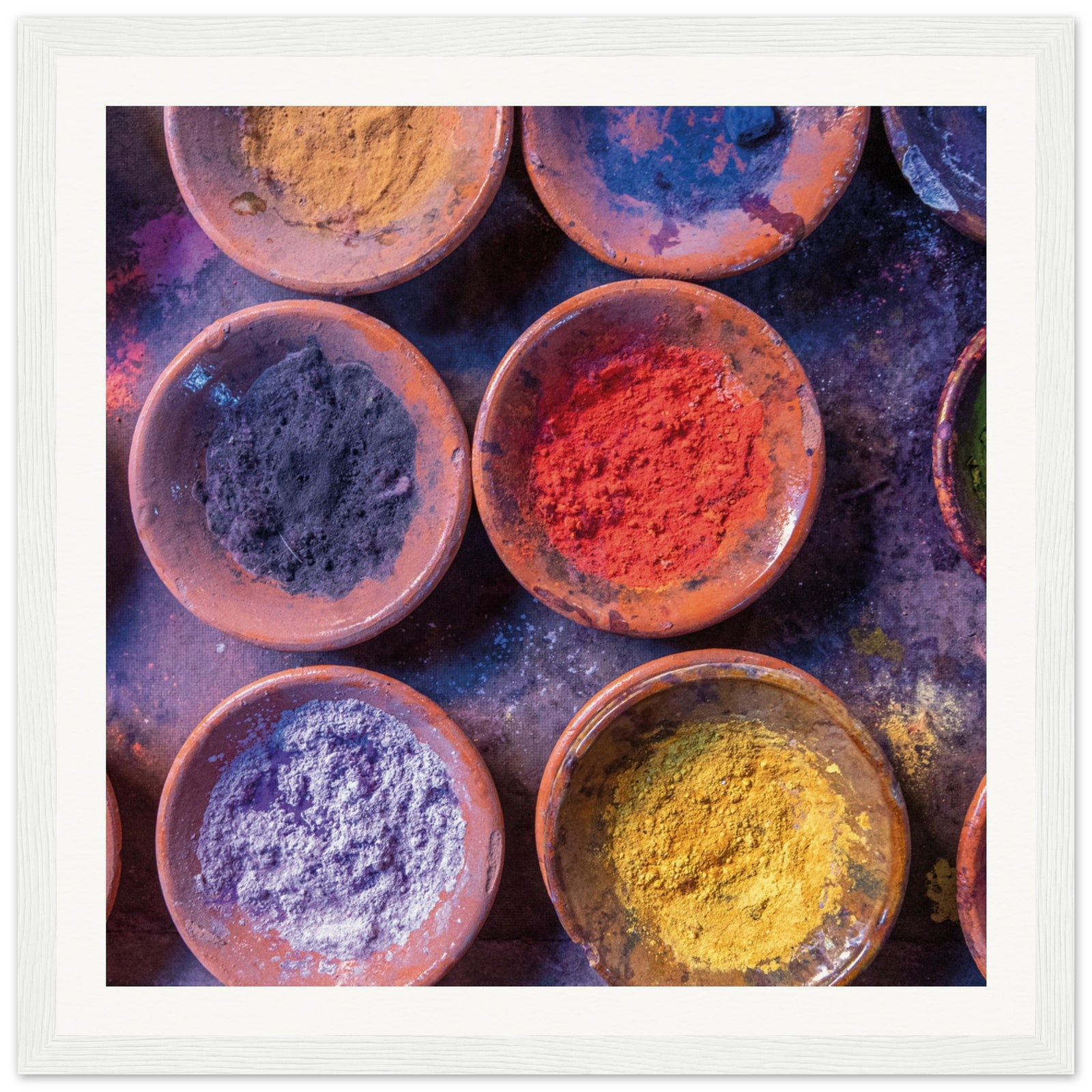 Rustic dishware holding powdered colors in an artistic arrangement.