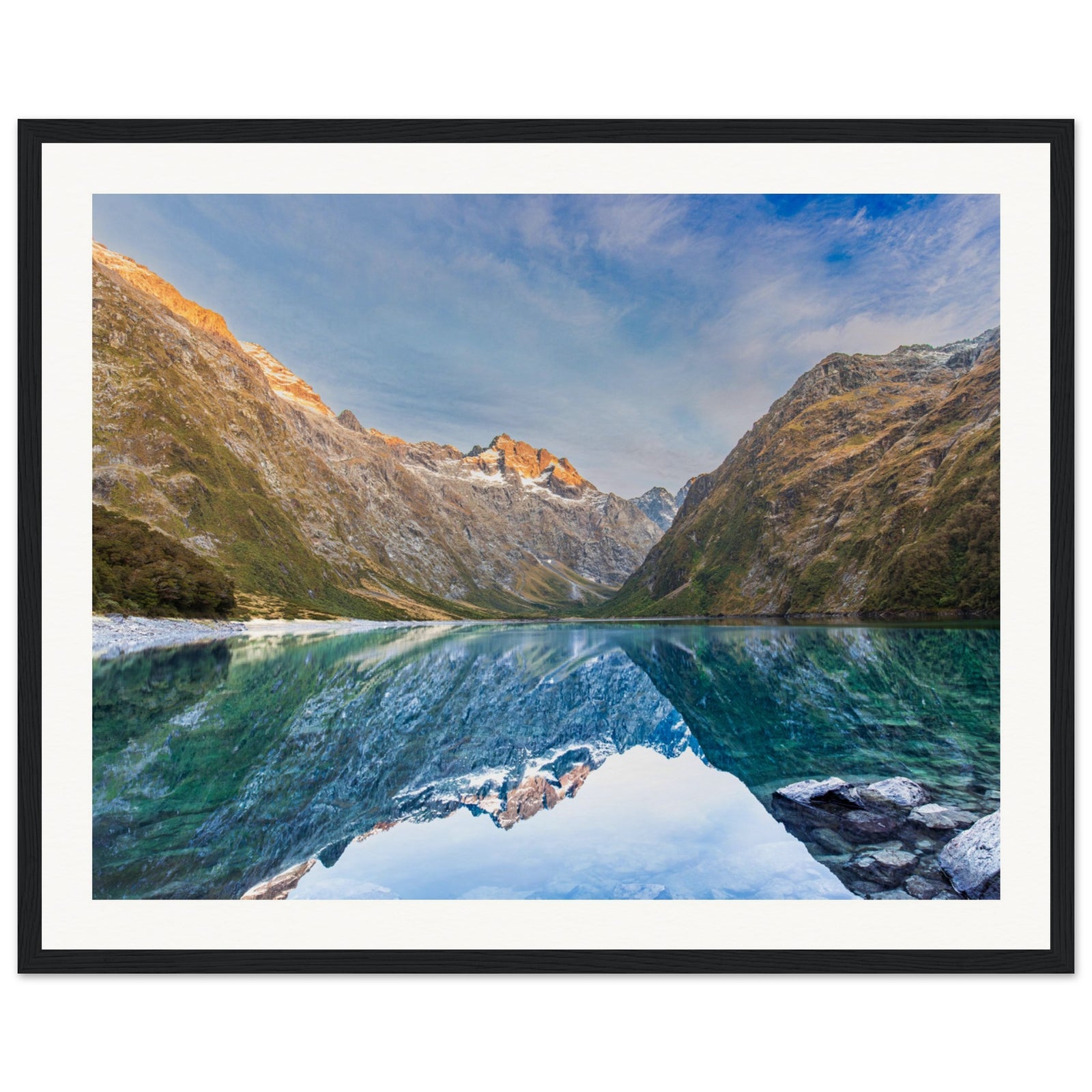 Landscape portrait with mirrored lake and blue dot on the mountain.