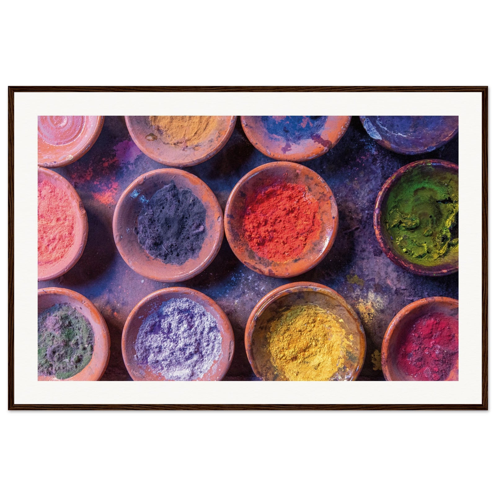 Artistic shot of natural pigment powders arranged in ceramic containers.