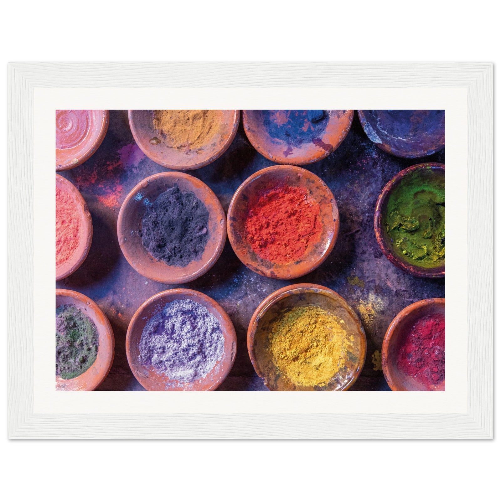 Clay dishes filled with bright powders arranged for visual impact.