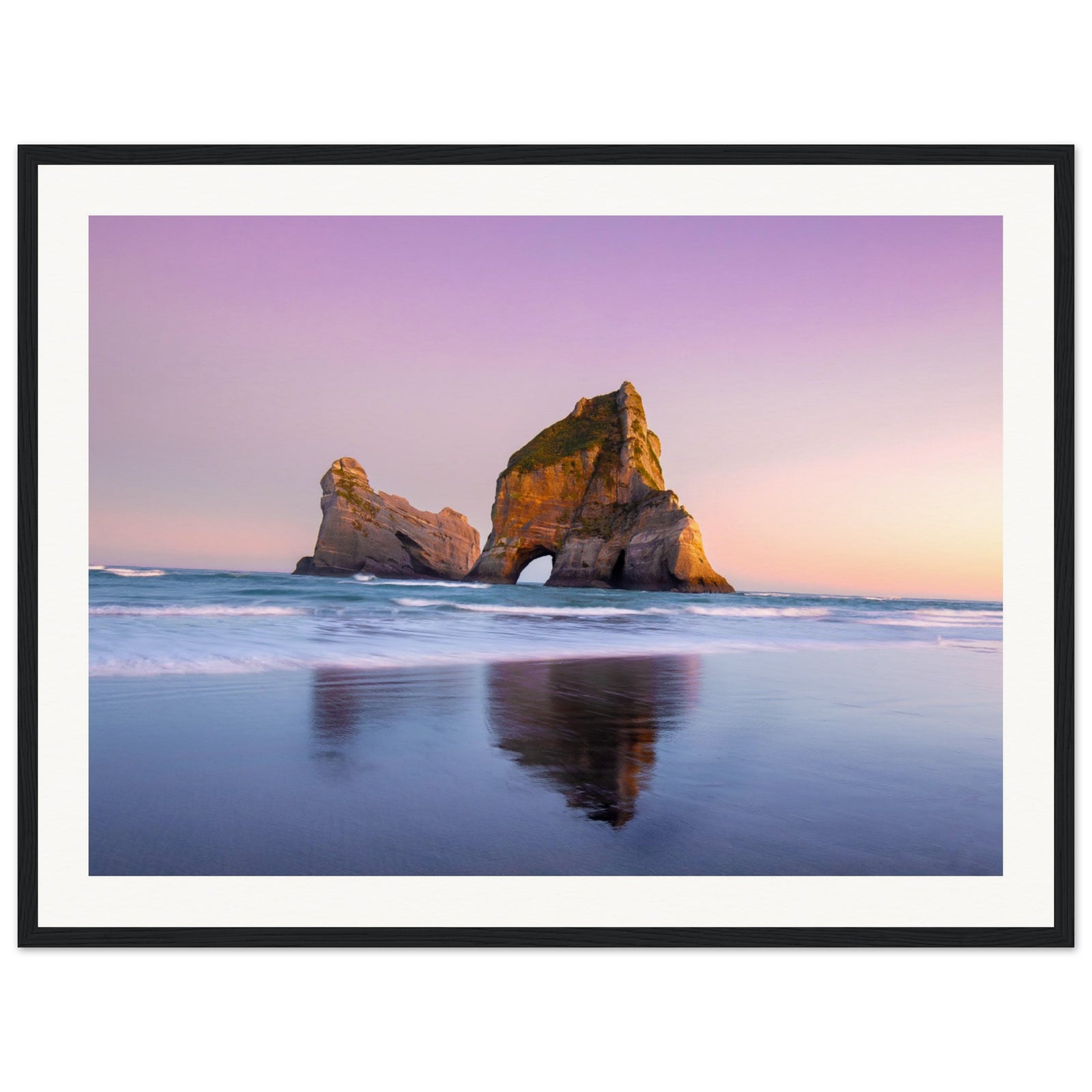 Framed sunset view with ocean rock structure in calm water.