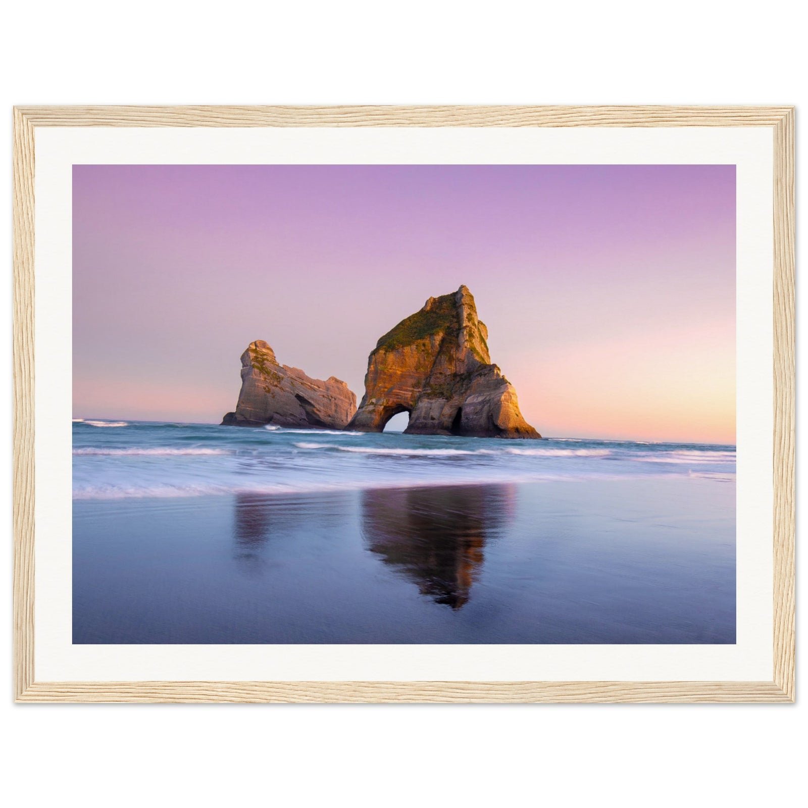 Sunset beach view with rock reflection in a vertical frame.