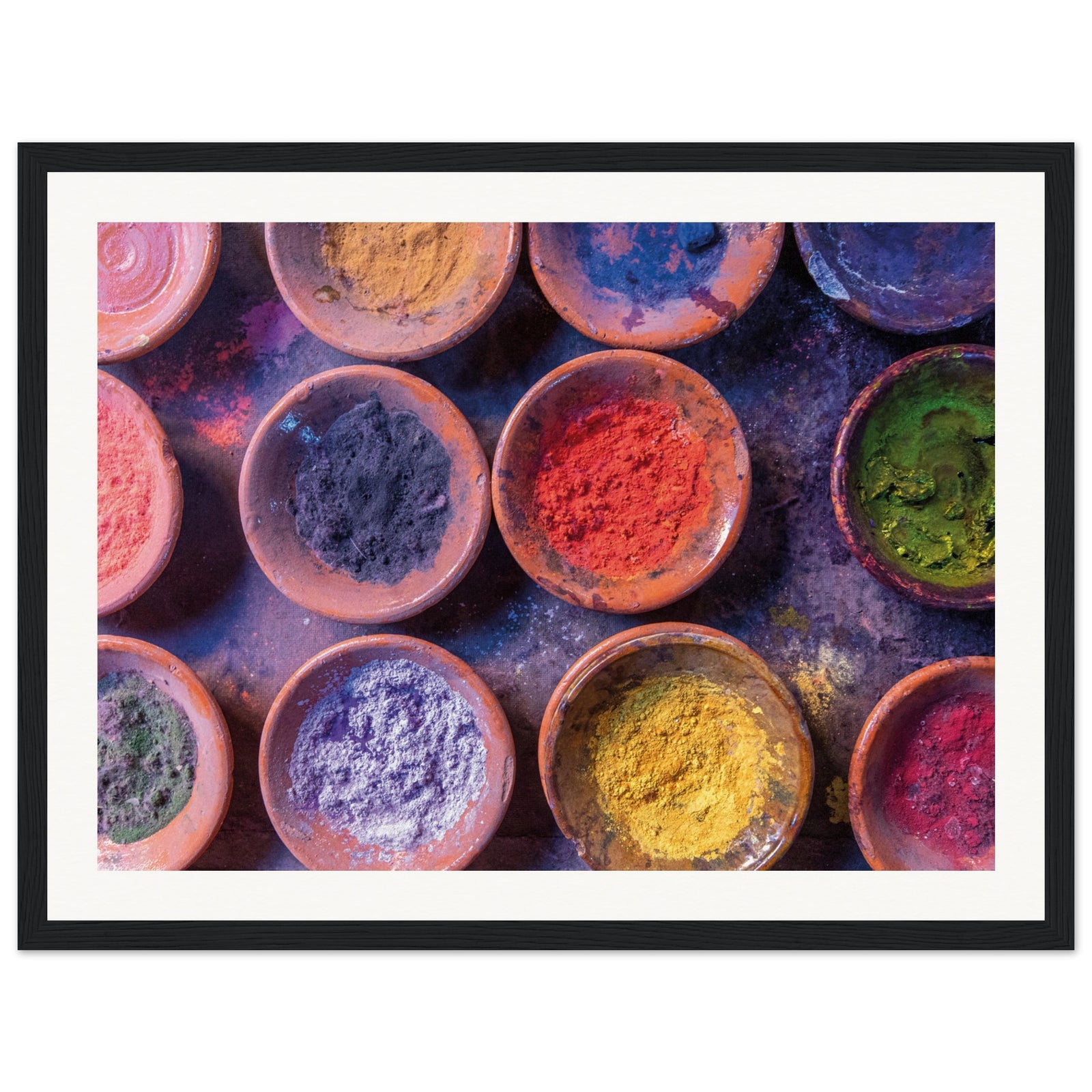 Flat-lay photo of colorful powders in terracotta vessels.
