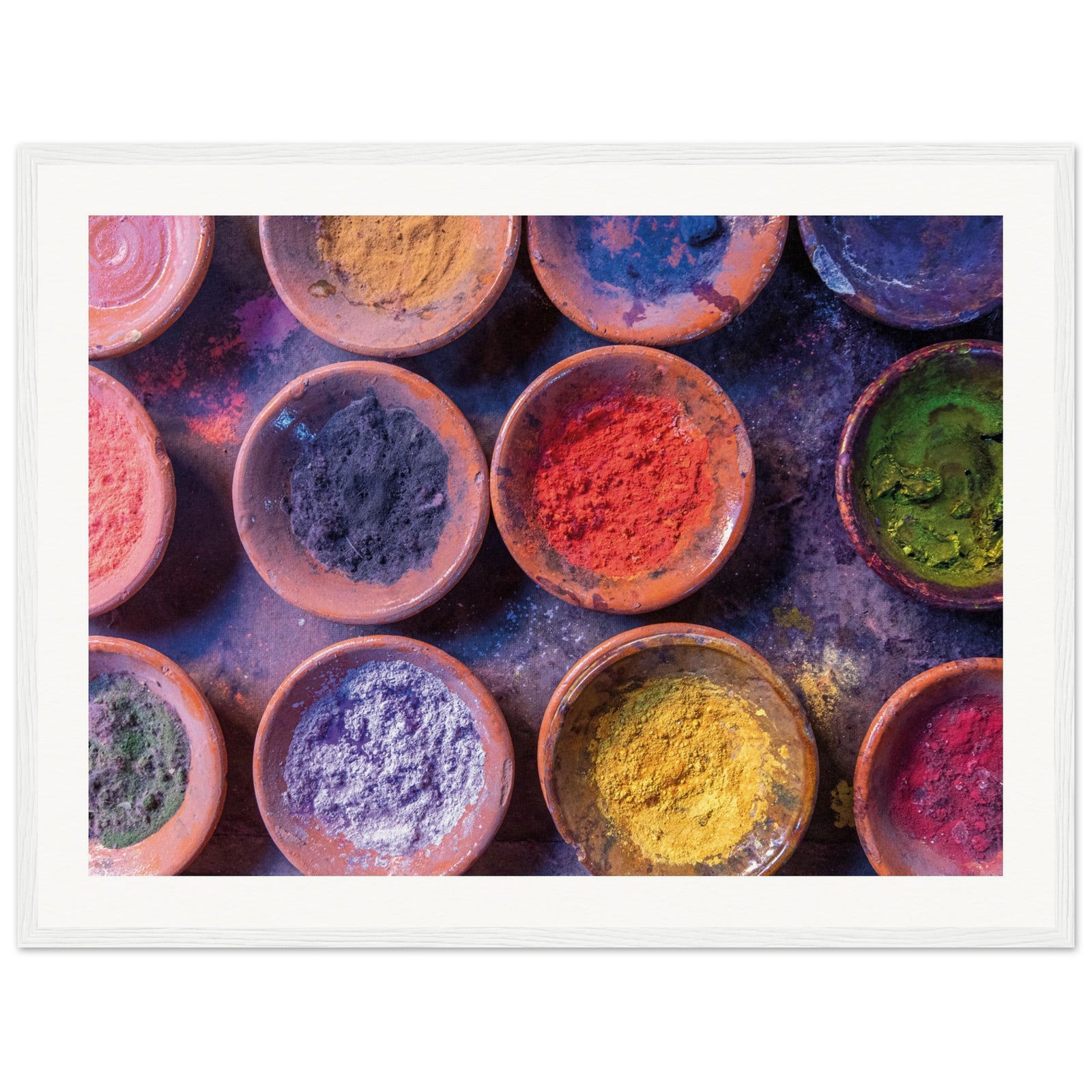 Framed artwork of color bowls used in traditional festivals.
