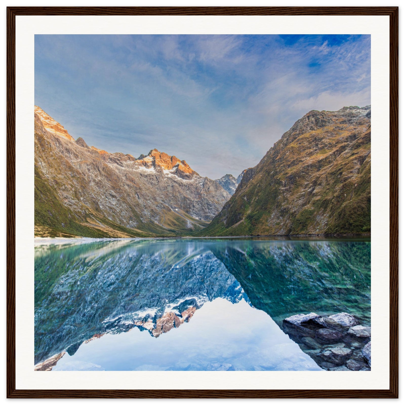 Framed mountain valley with glowing ridges and a blue dot.