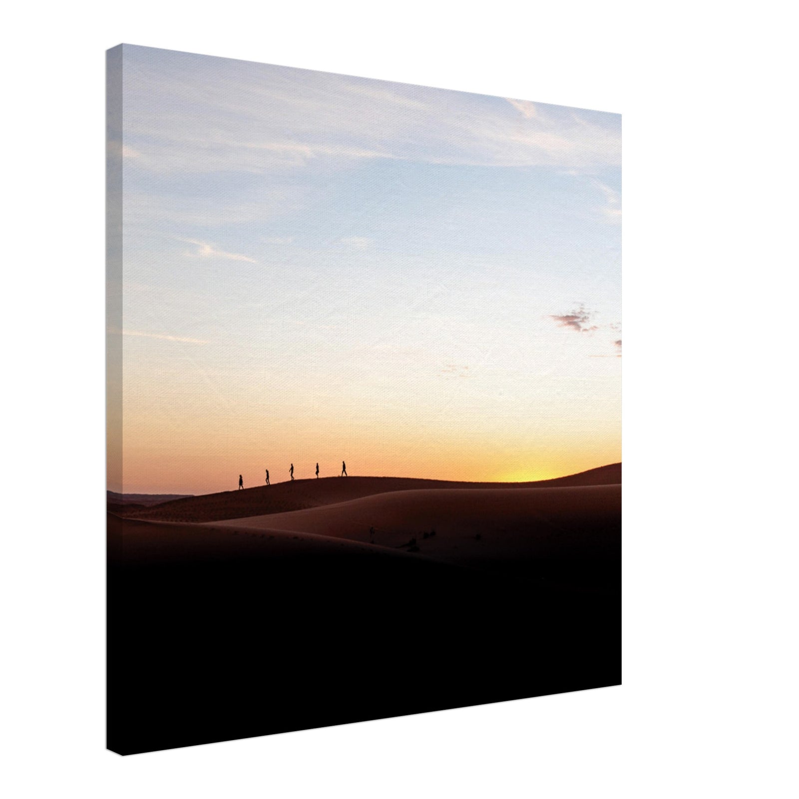 Hikers silhouetted on the crest of desert hills.
