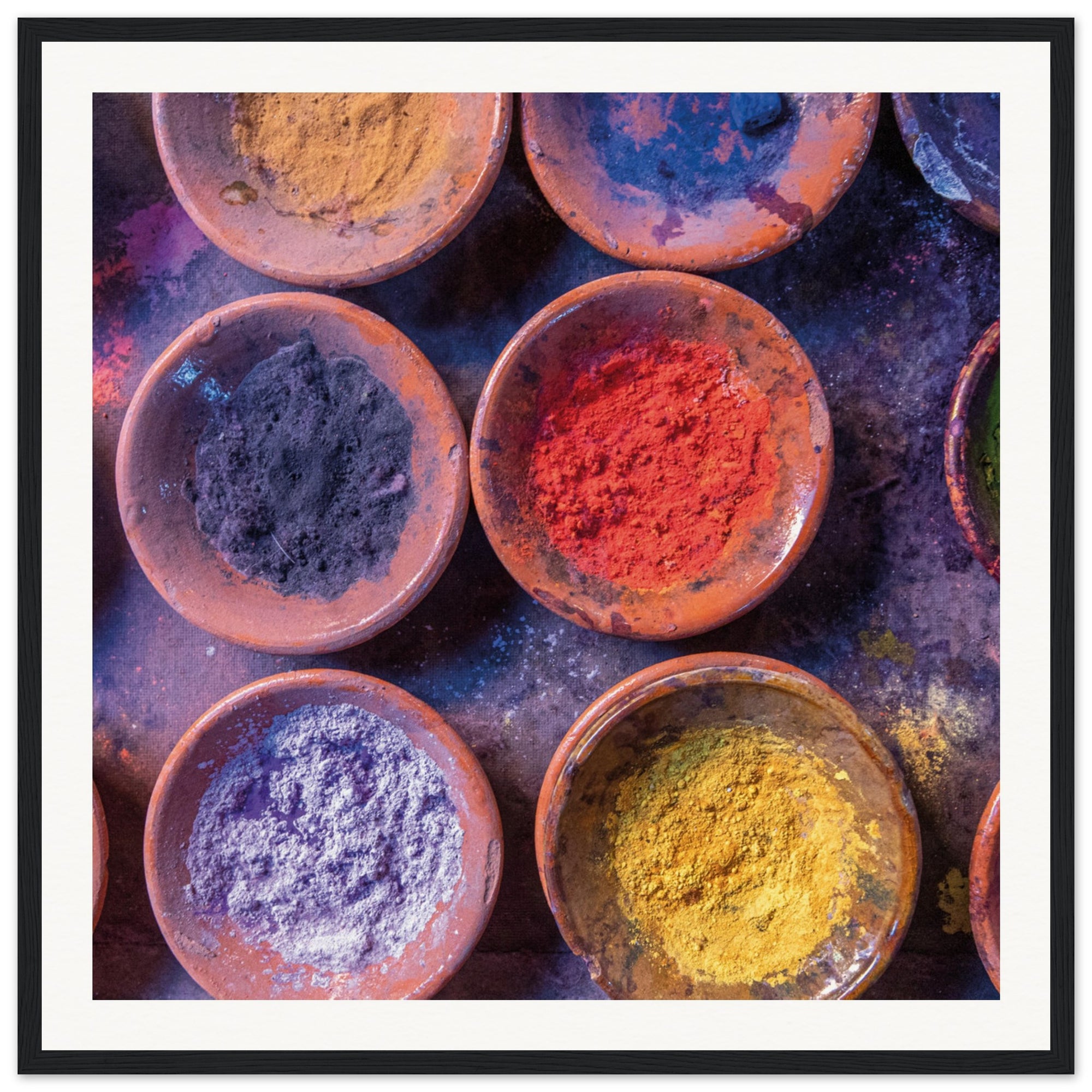 Bright and bold color arrangement in a series of small pottery bowls.

