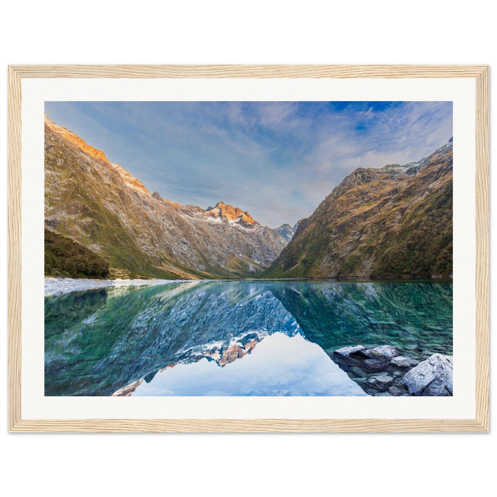 Reflective lake and mountain portrait with a small blue dot on the slope.

