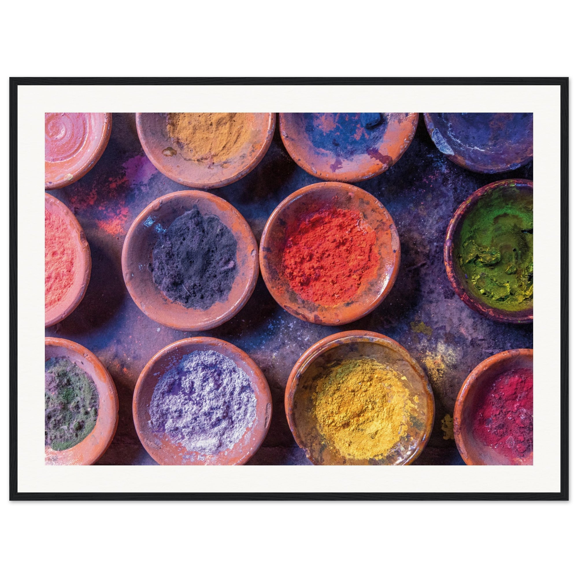 Framed photo of colorful festival powders in rustic round dishes.

