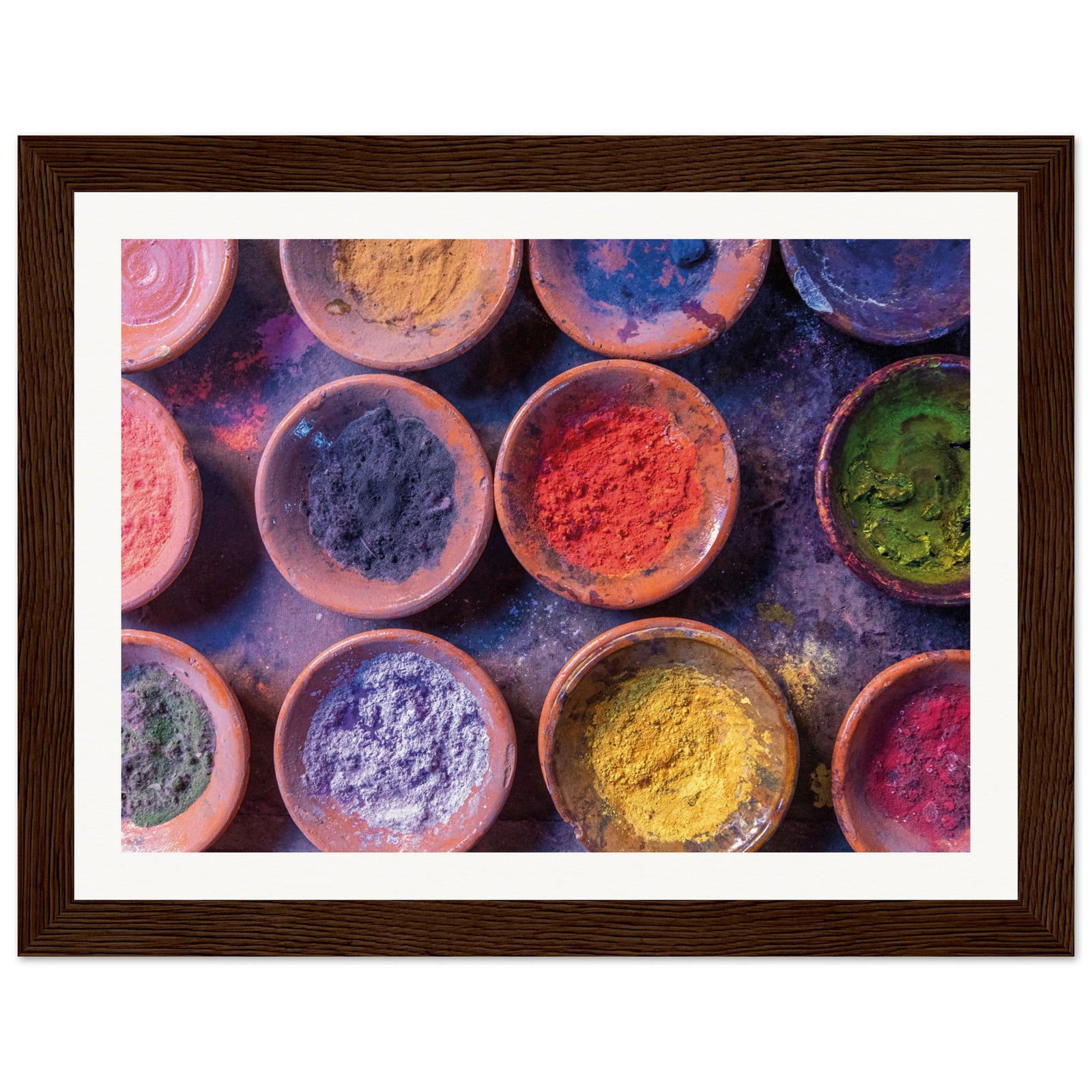 Framed color splash featuring ceramic bowls filled with vibrant dust.

