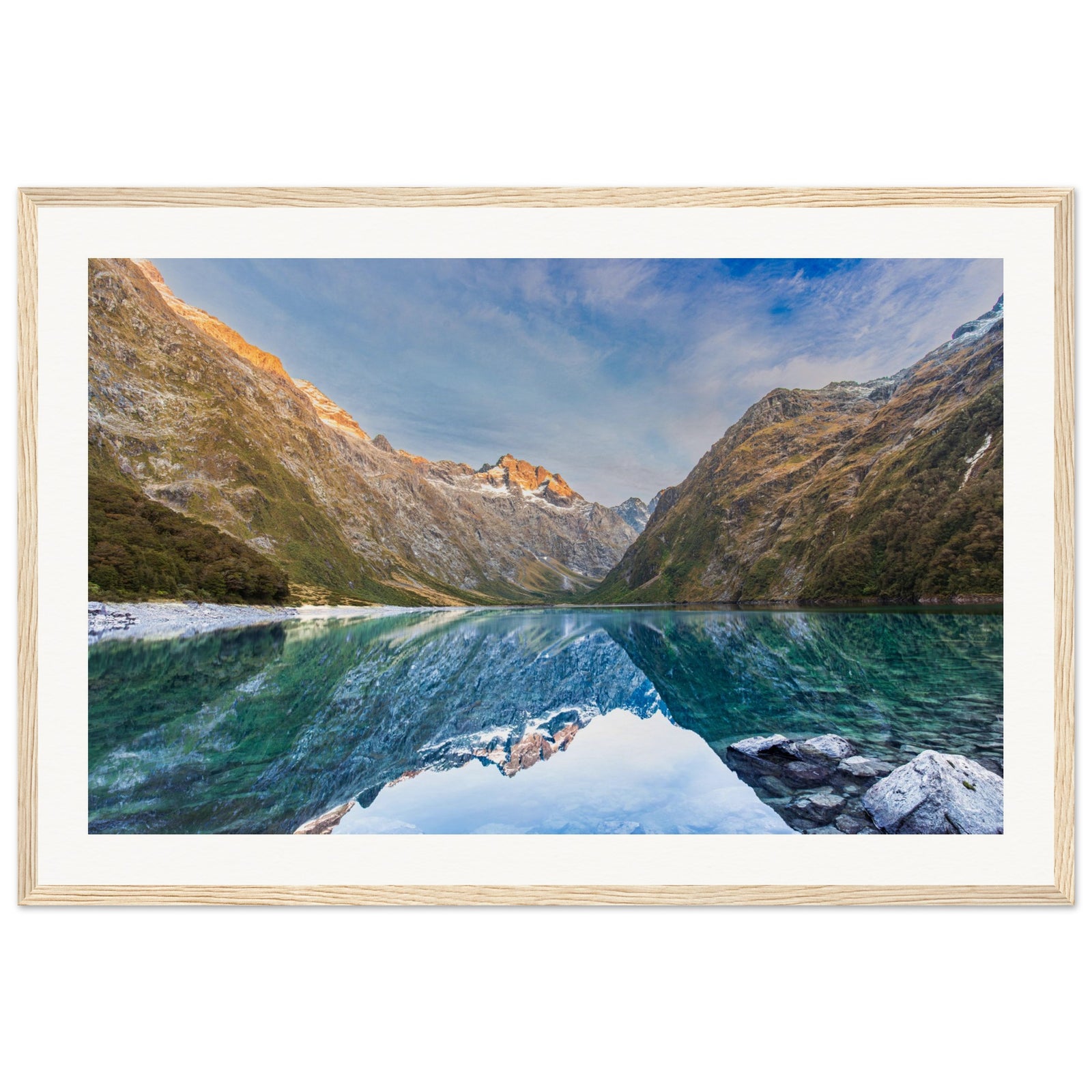 Framed photo with reflective lake and highlighted terrain.

