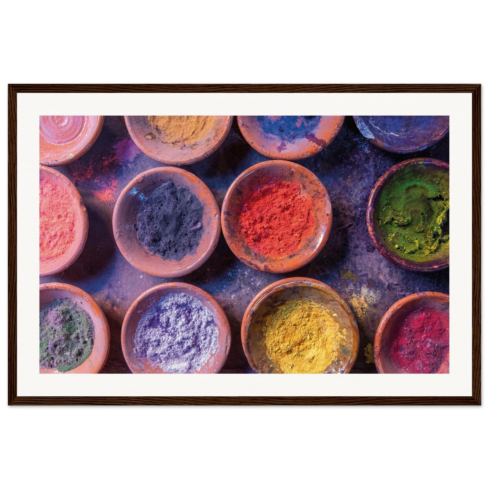 Framed cultural pigment powders in symmetrical dish layout.

