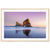 Framed photo of rock formation in water at twilight.