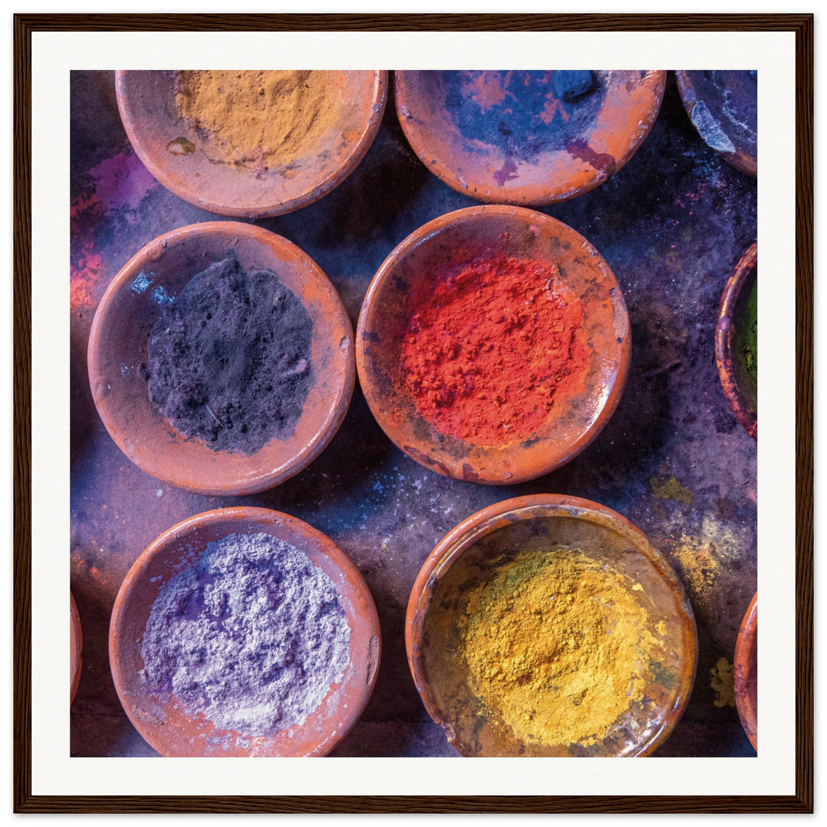 Framed top-down perspective of pigments ready for artistic use.

