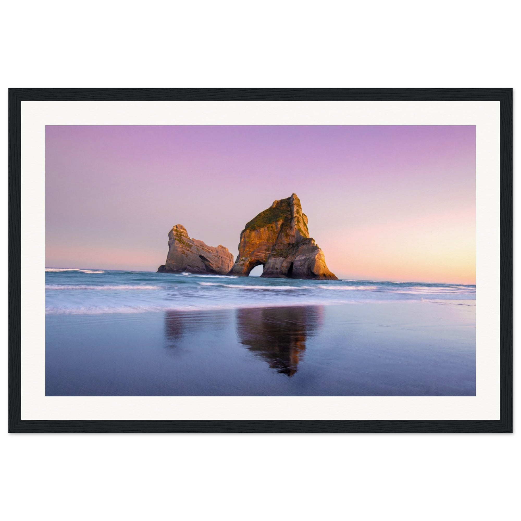 Framed vertical image of shoreline and sea rock at twilight.

