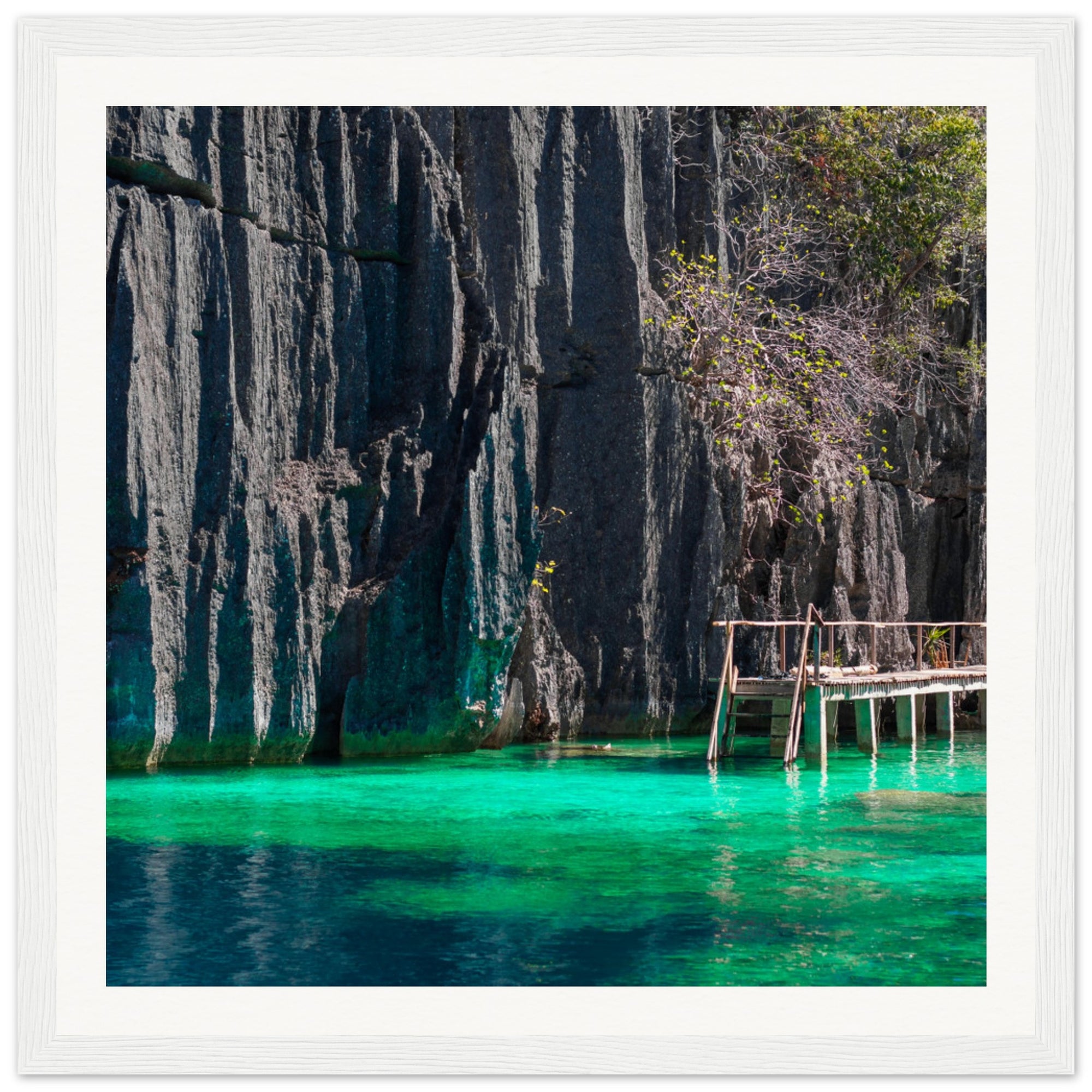 Framed island escape featuring cliffs, water, and simple wooden dock.

