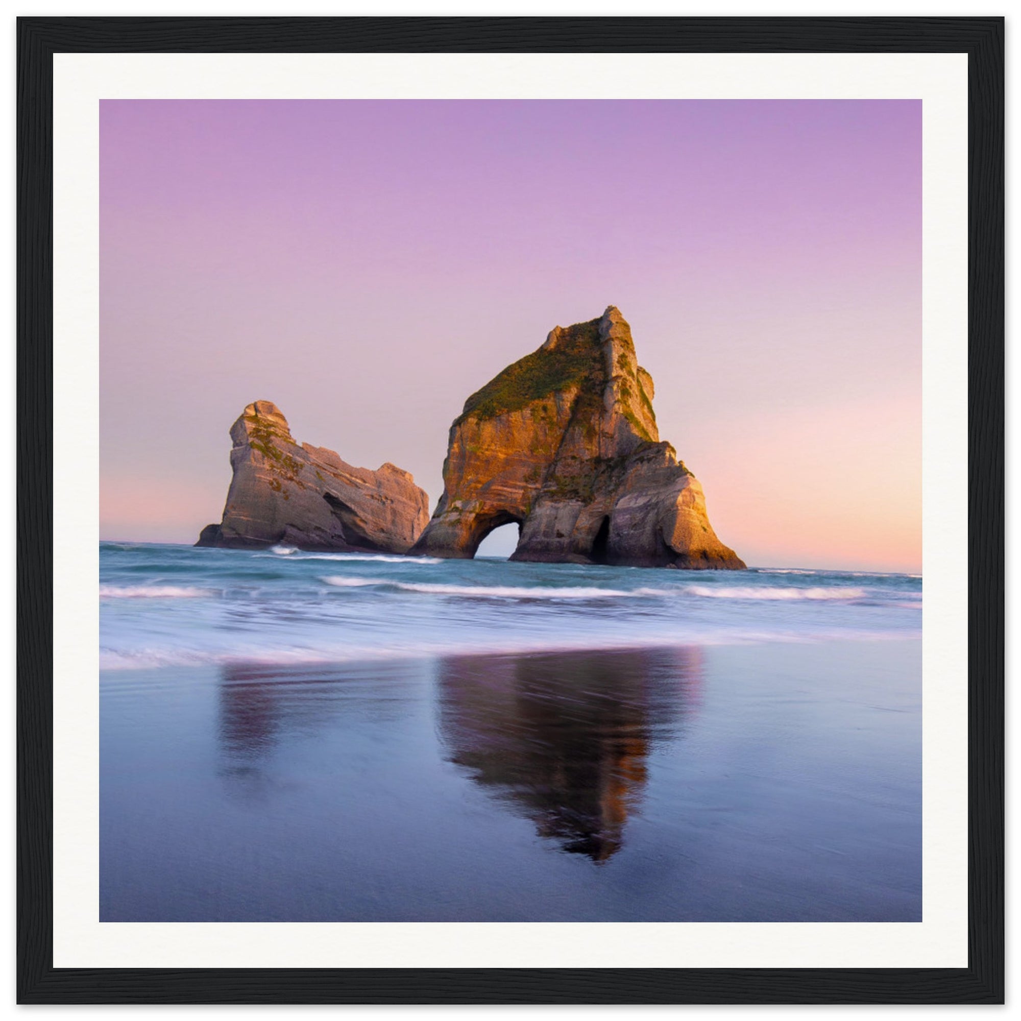 Sunset horizon meets sea rock arch in vertical photo.

