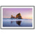 Softly lit ocean view with reflective sand and rock structure.

