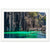 Portrait of a tropical cliffside and calm water with a wooden pier.

