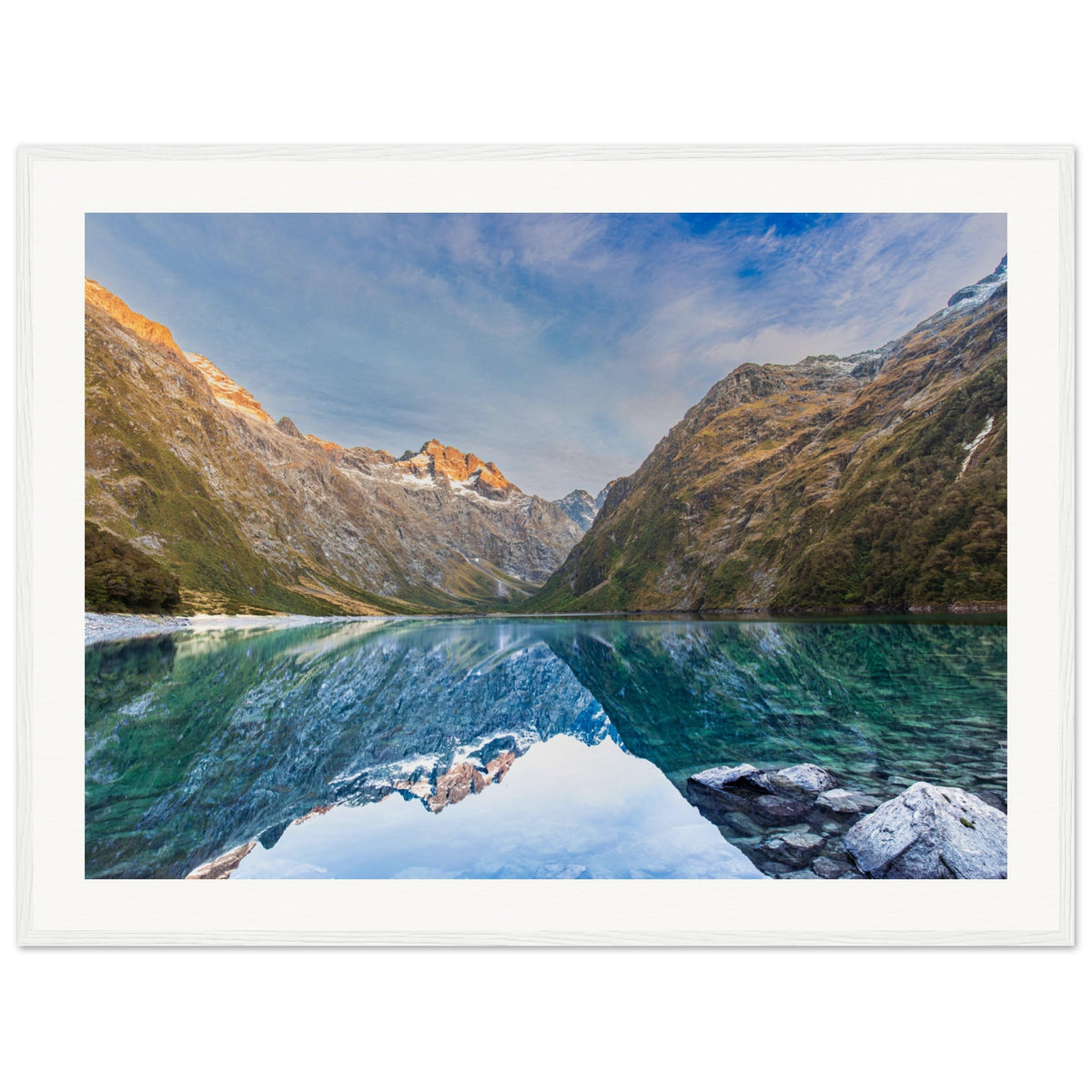 Nature portrait with a reflective lake and highlighted mountain slope.

