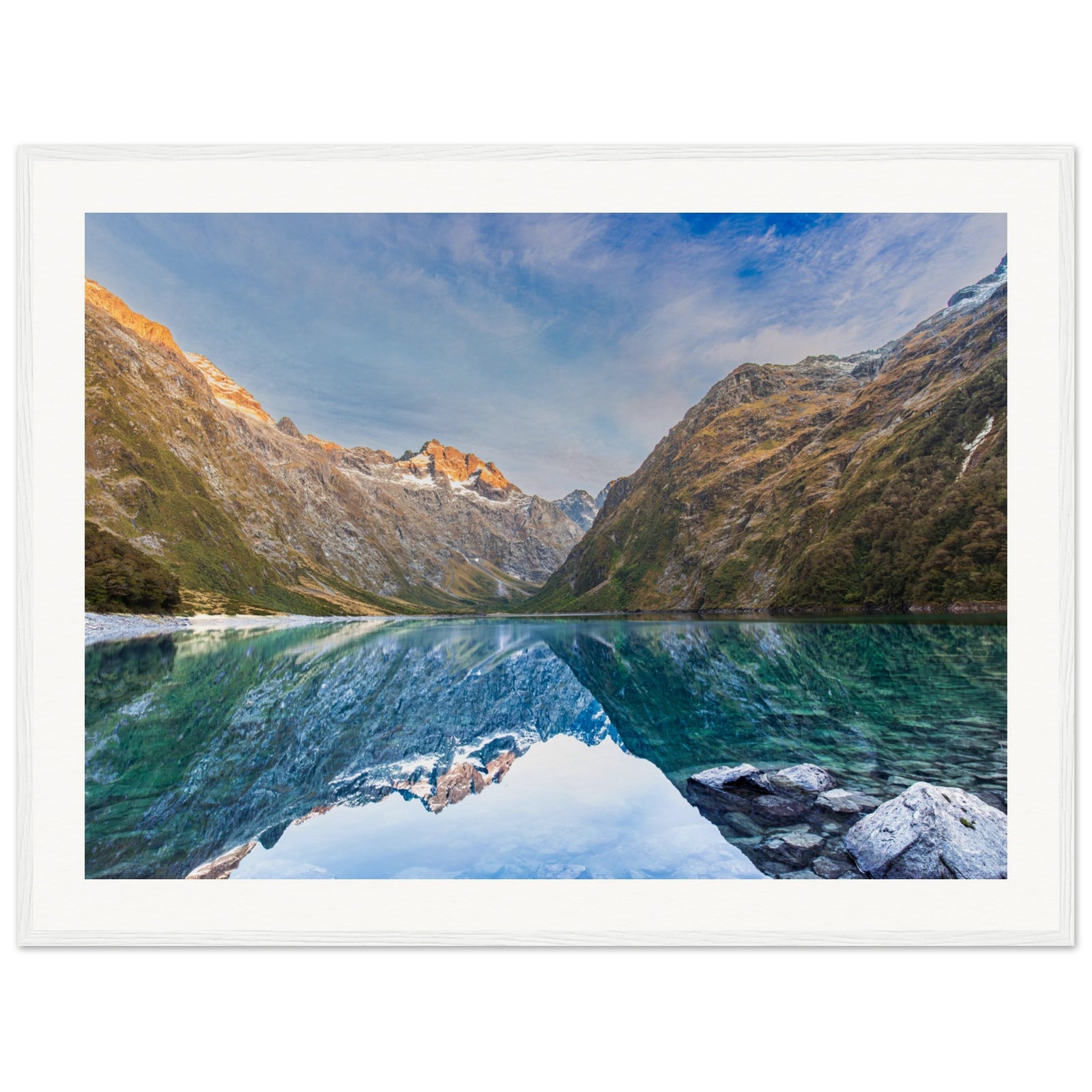 Nature portrait with a reflective lake and highlighted mountain slope.


