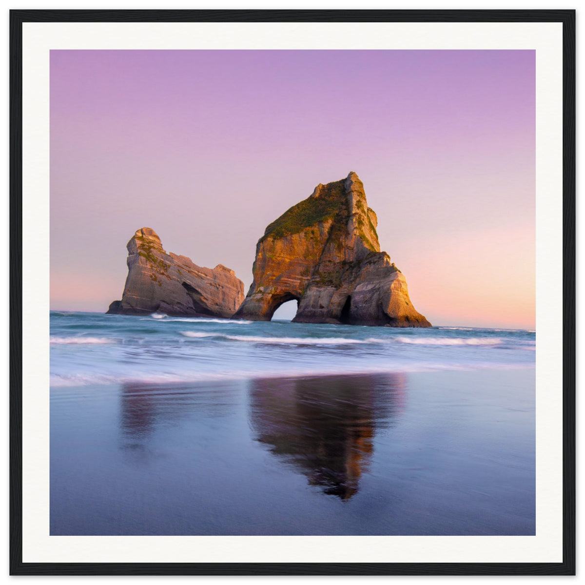 Framed beachscape of iconic arch and pastel ocean hues.

