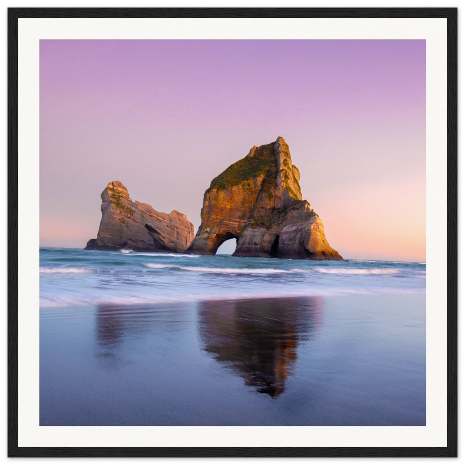 Framed beachscape of iconic arch and pastel ocean hues.

