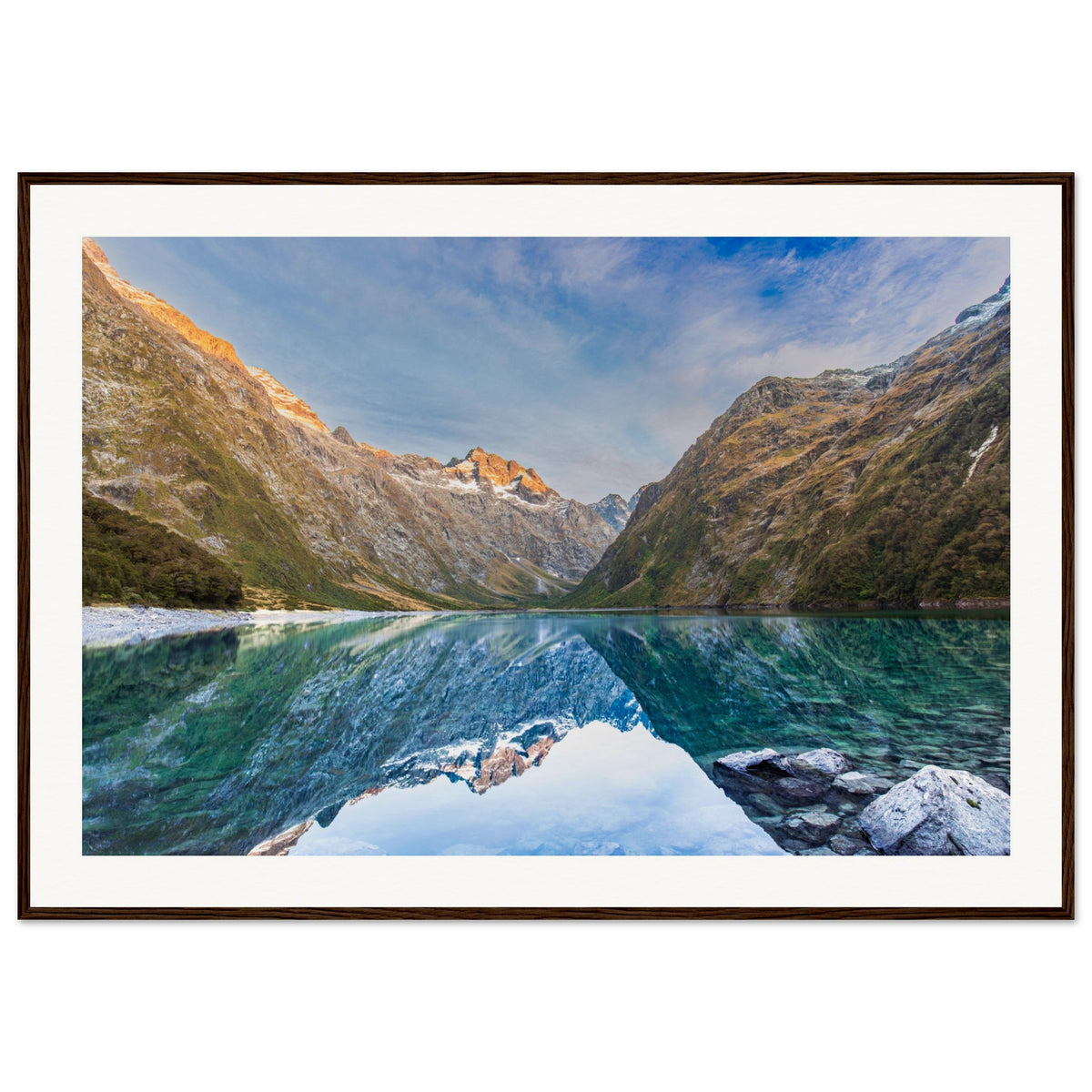 Framed artwork of tranquil mountain waters and highlighted ridge.

