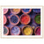 Terracotta bowls filled with colorful powders in a bright wall print.

