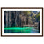 Emerald water reflecting limestone cliffs in a tropical framed portrait.

