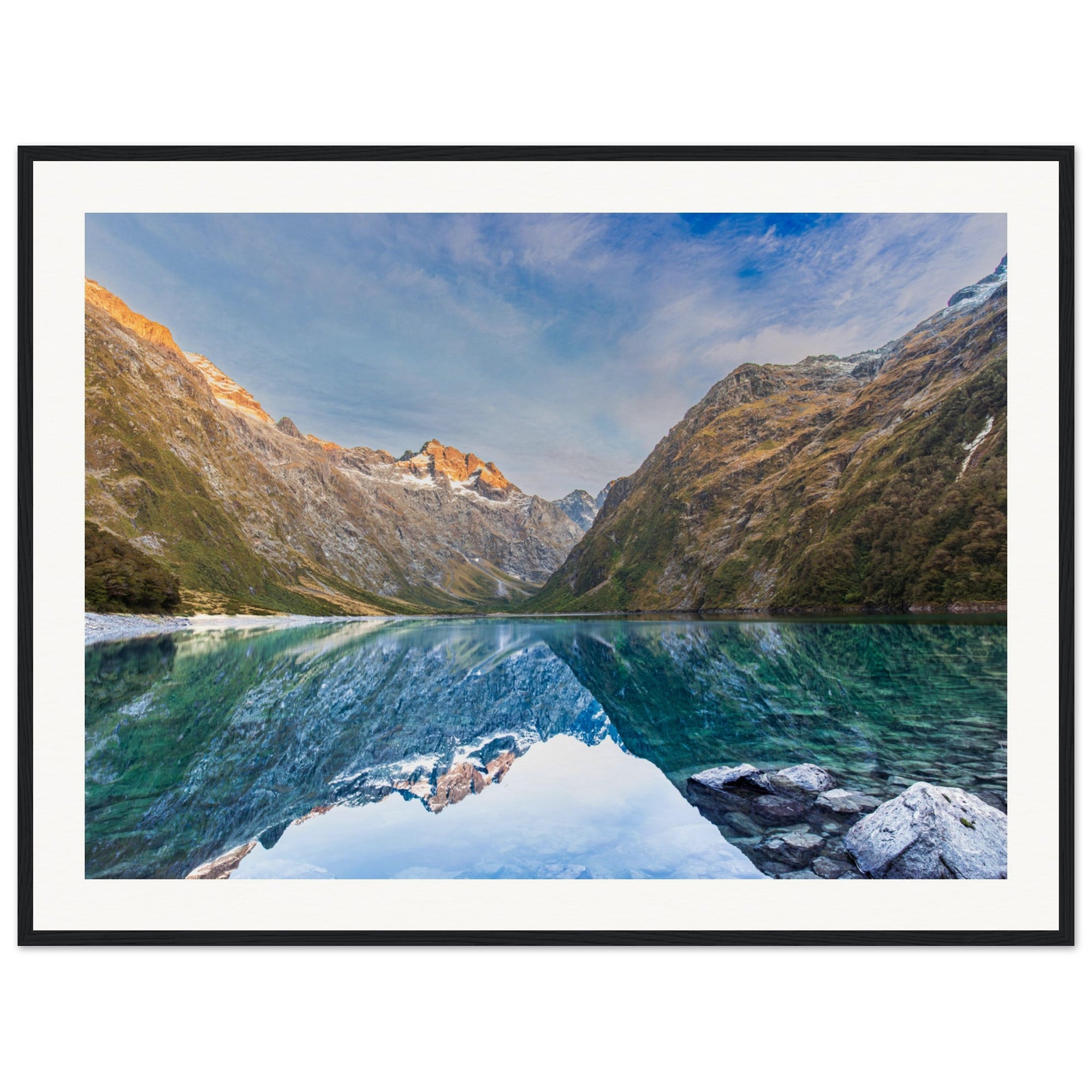 Framed portrait of a sunrise-lit valley and blue dot.

