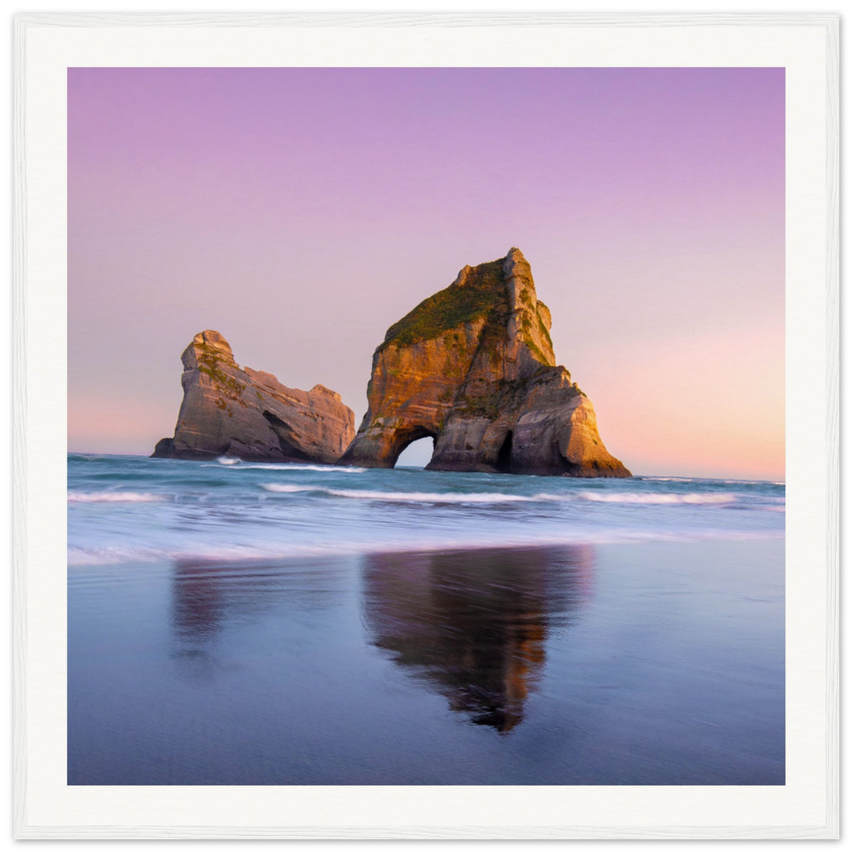 Reflected sea rock with pink sunset tones in a framed print.

