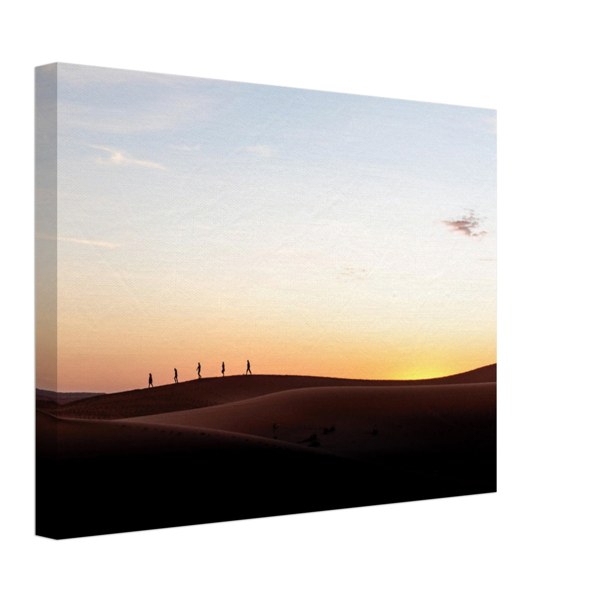 Rolling desert dunes with a line of tiny human figures.

