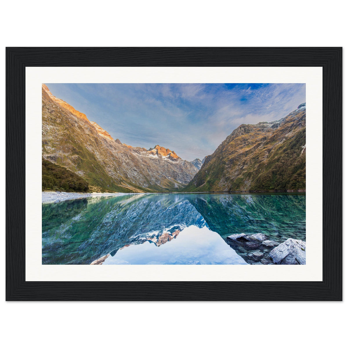 Framed landscape print showing lake reflections and a ridge marker.

