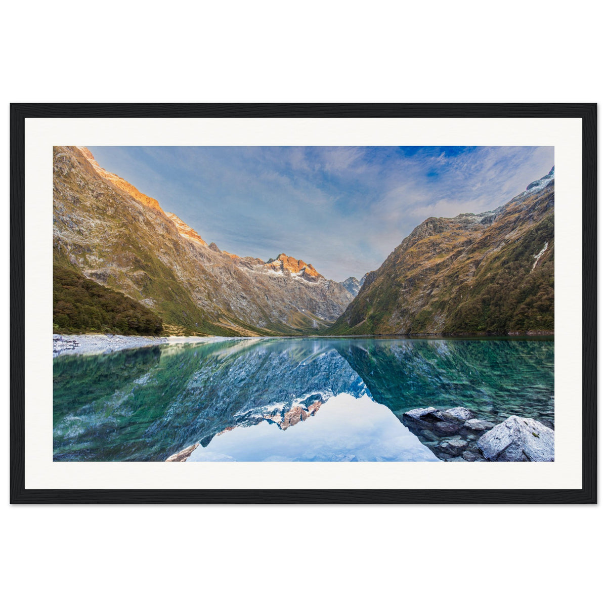 Framed portrait of a mountain lake scene with a blue dot on the slope.

