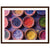 Colorful Holi powders set in earthy bowls as a framed artwork.

