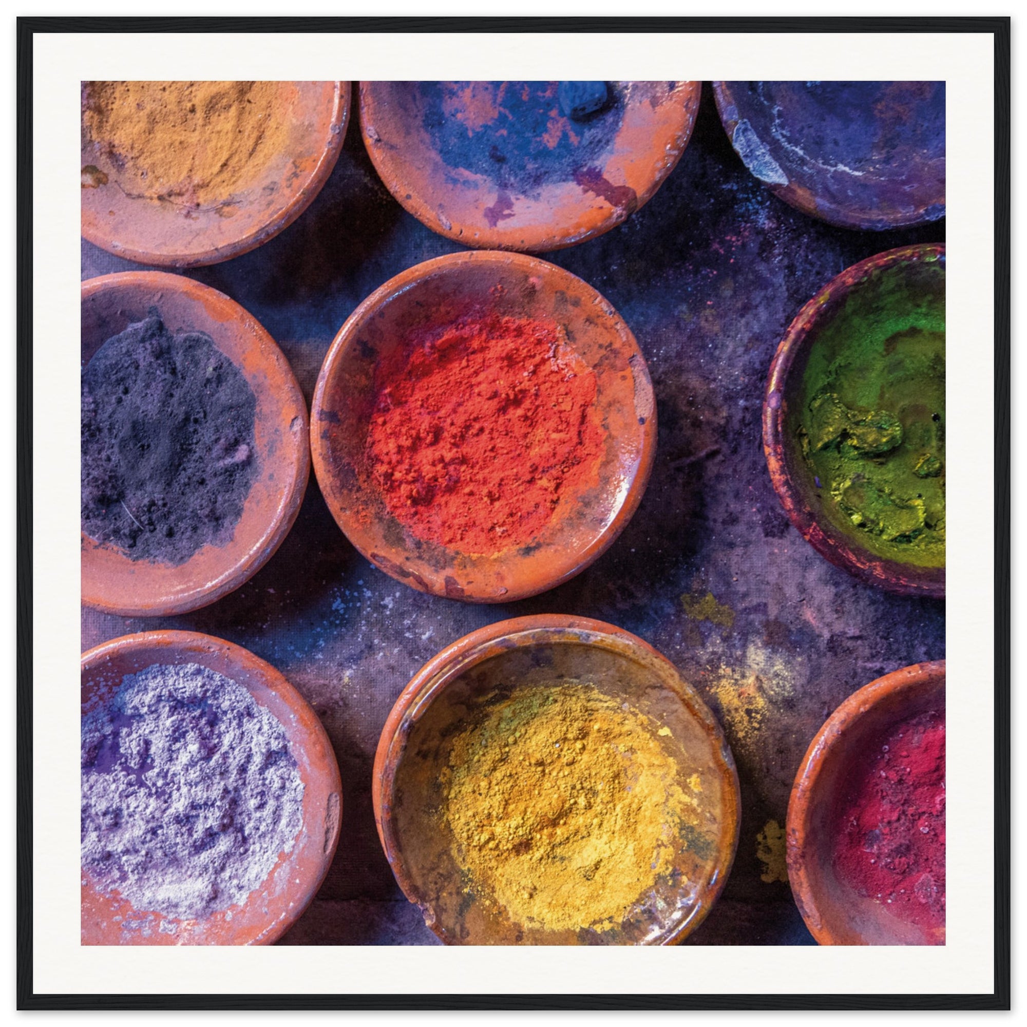 Circular bowls of vibrant hues in a framed art piece.

