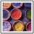 Circular bowls of vibrant hues in a framed art piece.

