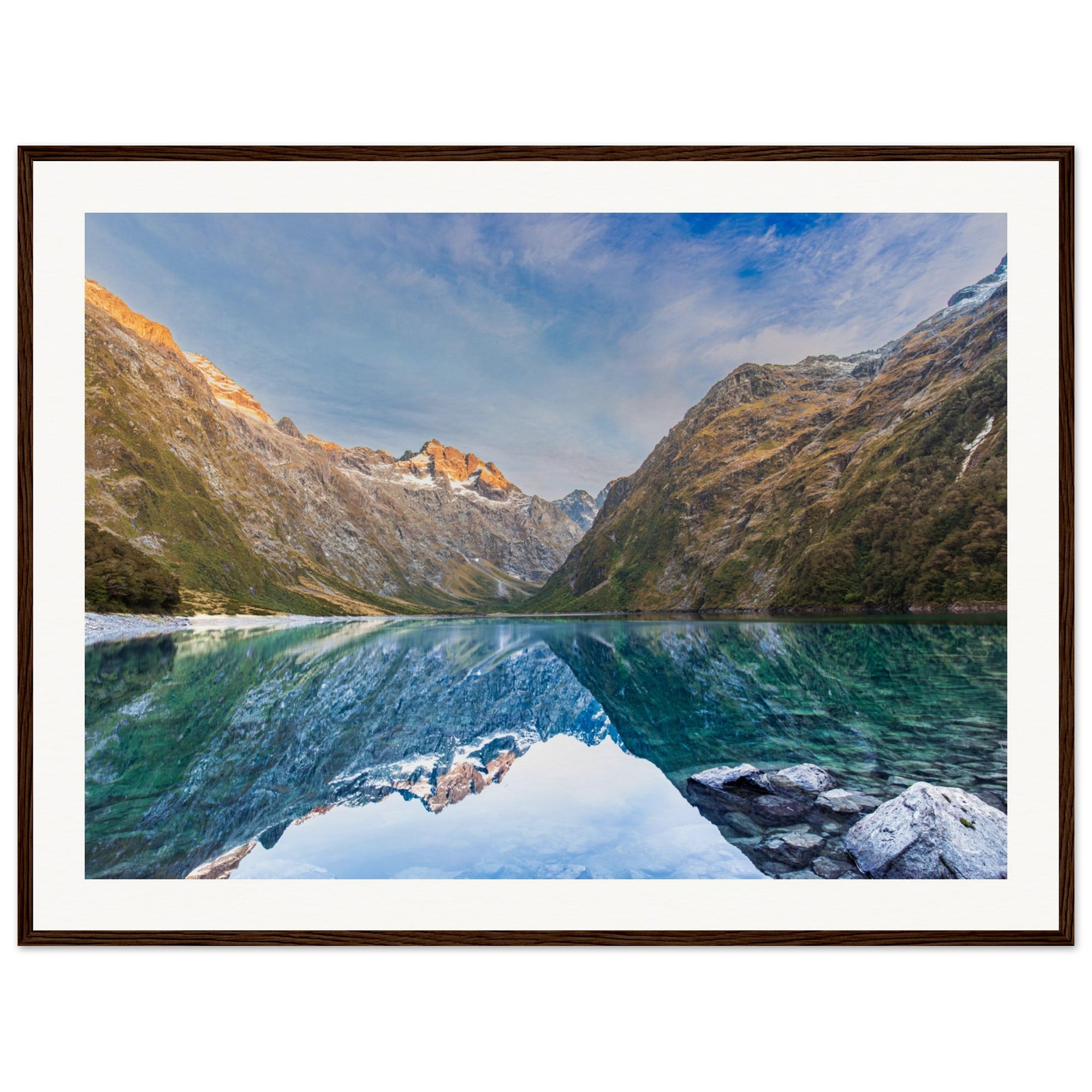 Framed photo of a sunlit alpine scene with dot marking terrain.

