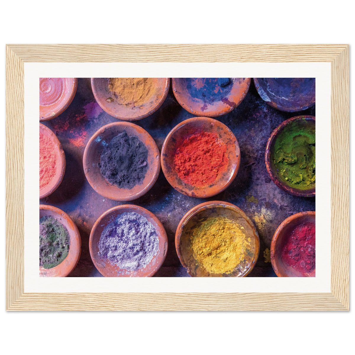 Overhead view of various powdered colors in symmetrical bowls.

