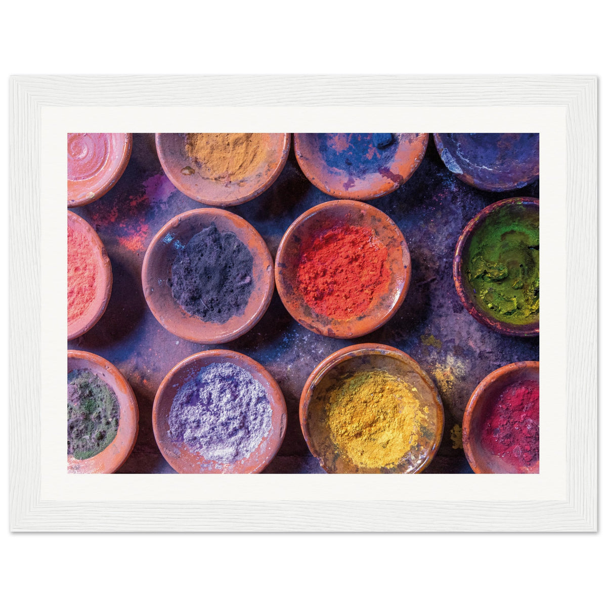 Clay dishes filled with bright powders arranged for visual impact.

